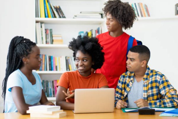 Group of african american and latin students coding app at computer at classroom of university